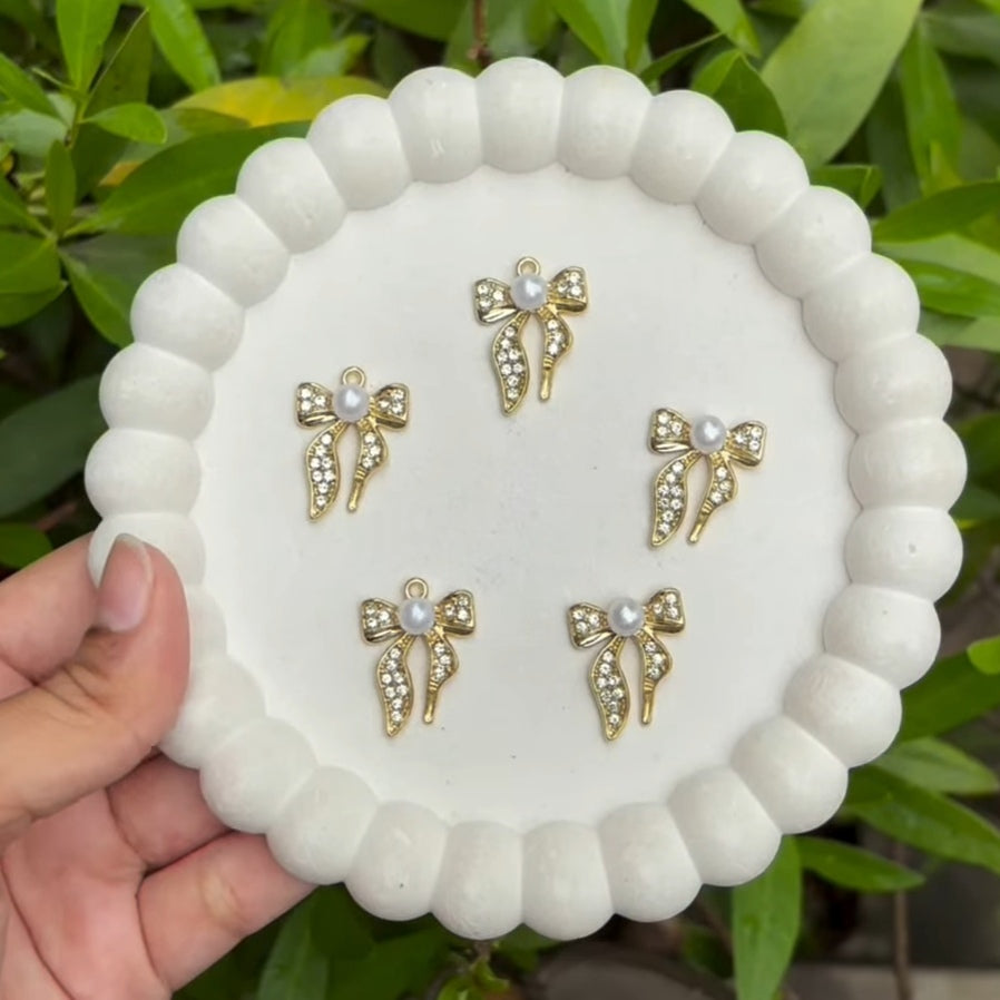 Golden bow charms